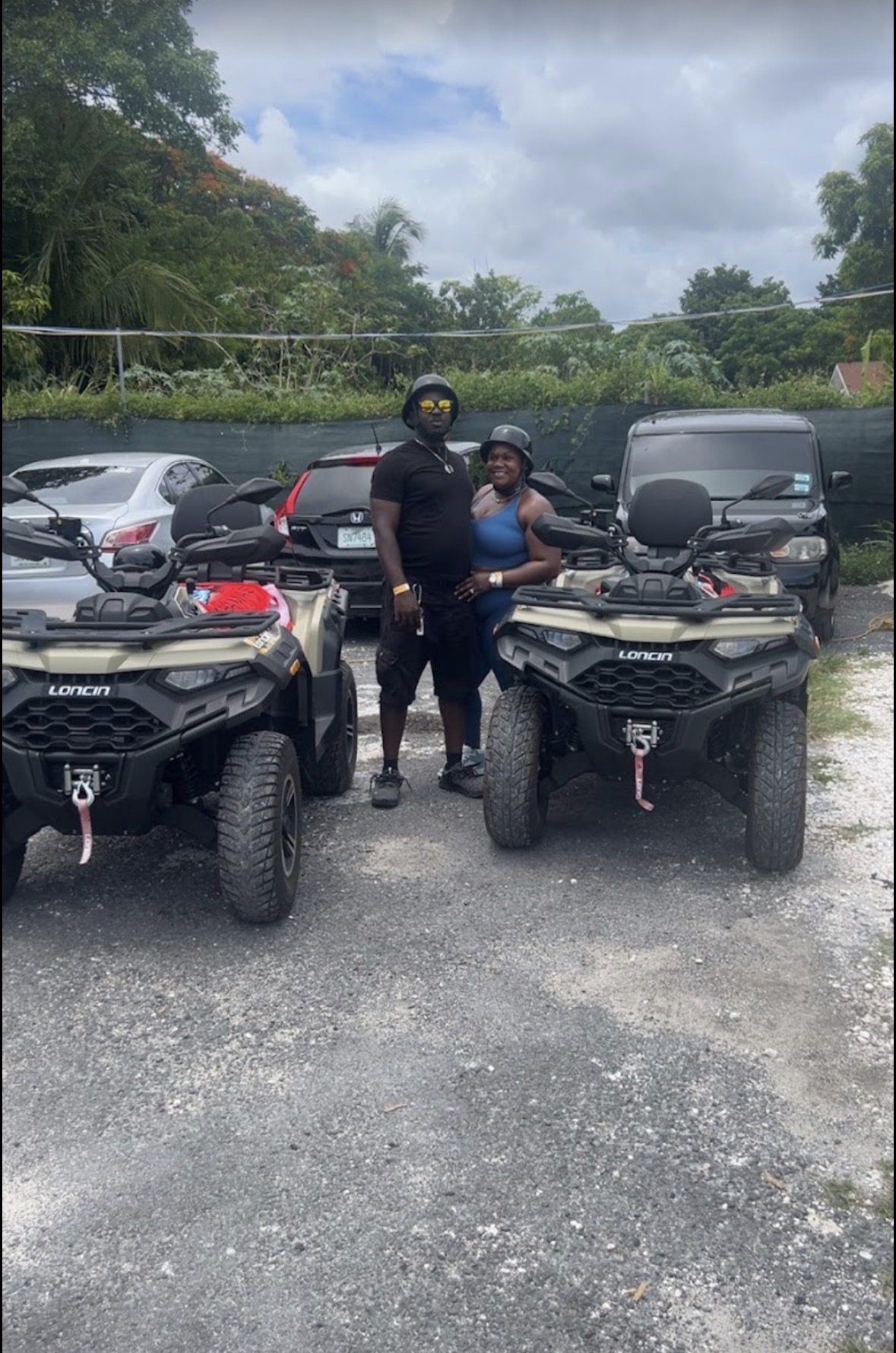 Two helmeted riders between their A2B ATVs in New Providence
